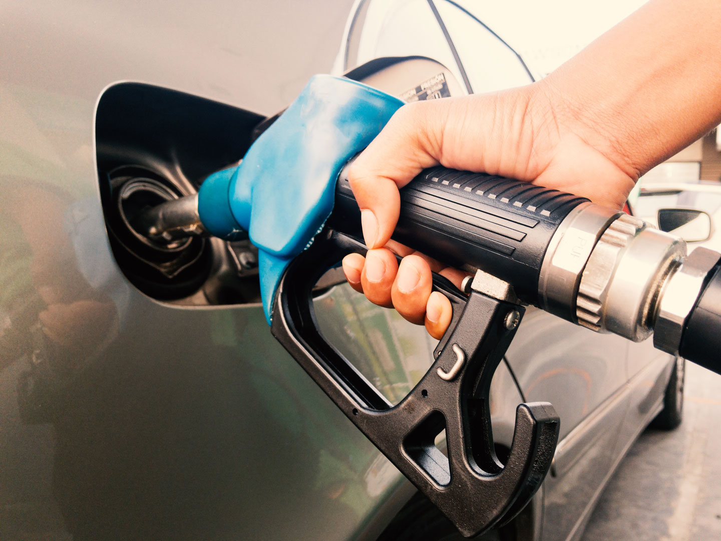 Hand,Holding,Gasoline,Nozzle,For,Car,Refueling,At,Gas,Station